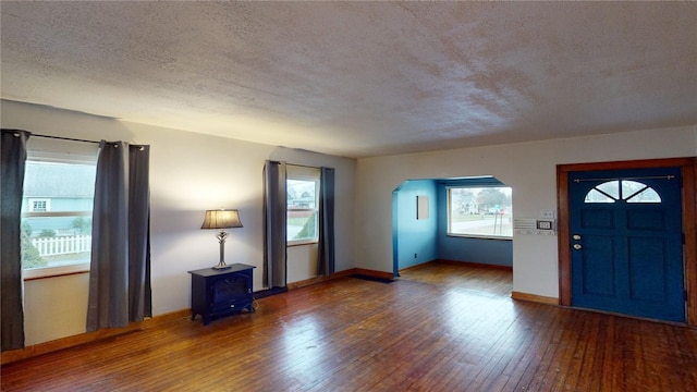 foyer with hardwood / wood-style floors and a textured ceiling