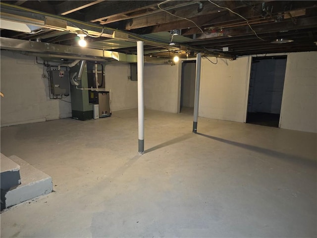 basement featuring heating unit and electric panel