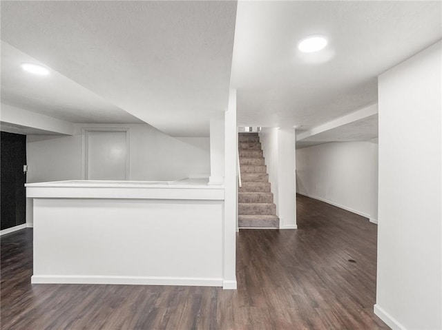 unfurnished living room featuring dark hardwood / wood-style flooring