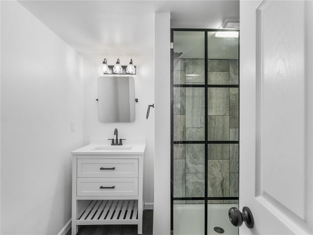 bathroom with walk in shower and vanity