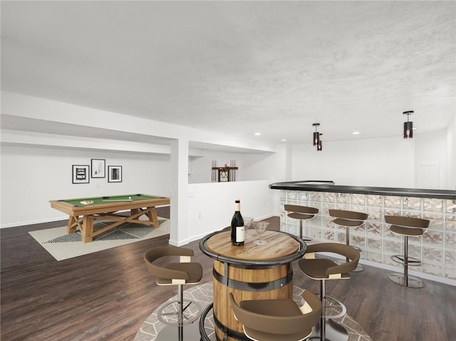 bar featuring hanging light fixtures, a textured ceiling, dark hardwood / wood-style flooring, and billiards