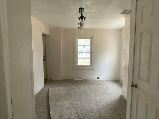 spare room featuring light colored carpet