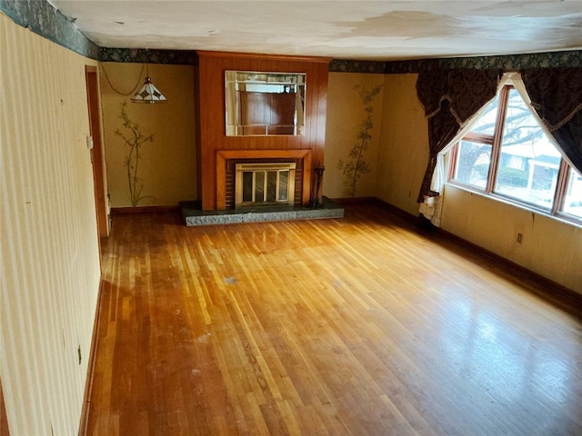 unfurnished living room with a fireplace and wood-type flooring