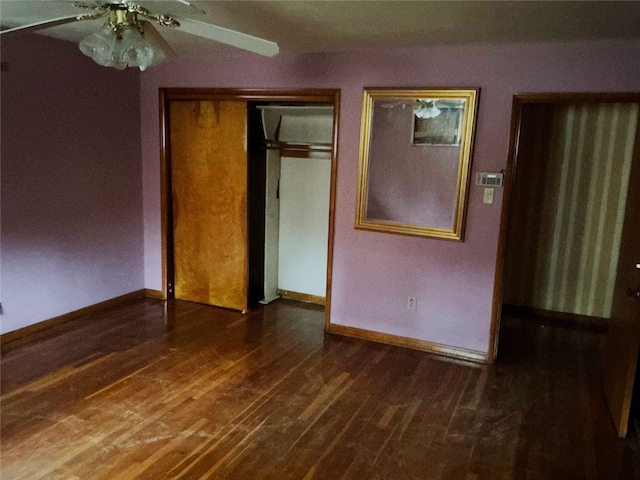 unfurnished bedroom featuring ceiling fan, dark hardwood / wood-style floors, and a closet