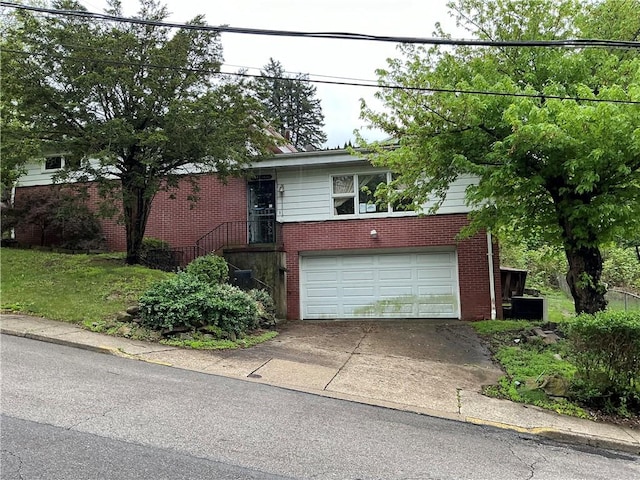 125 Webster St, Rochester Twp, PA 15074 - view of front facade with an attached garage, brick siding, and concrete driveway
