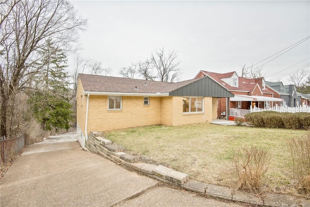 rear view of house with a yard and a porch