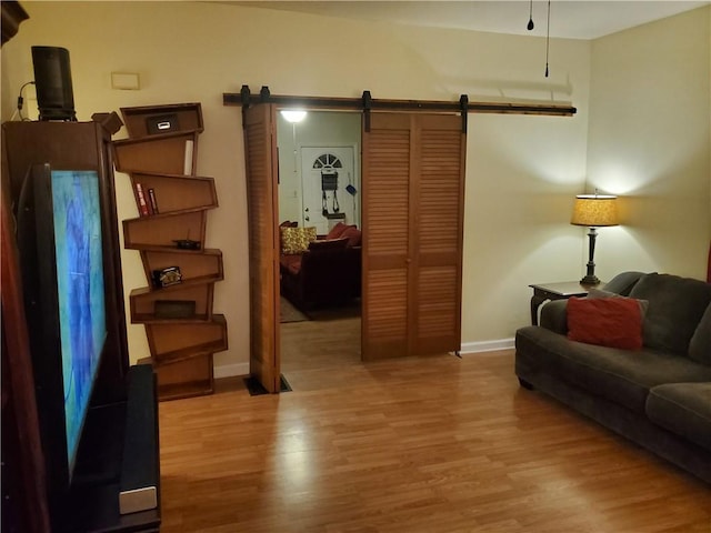 living room with hardwood / wood-style flooring and a barn door