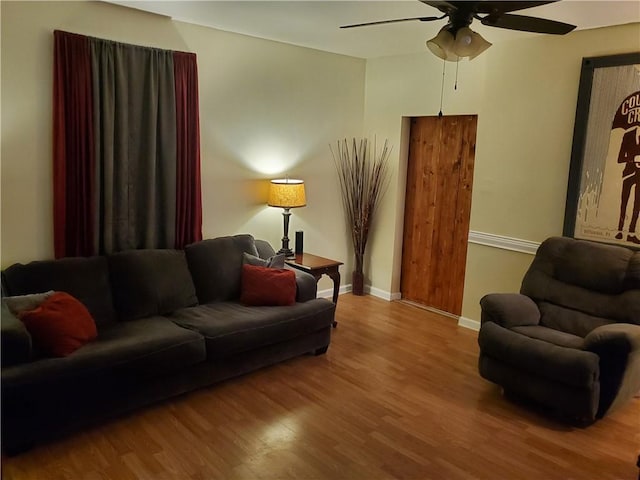 living room featuring hardwood / wood-style flooring and ceiling fan