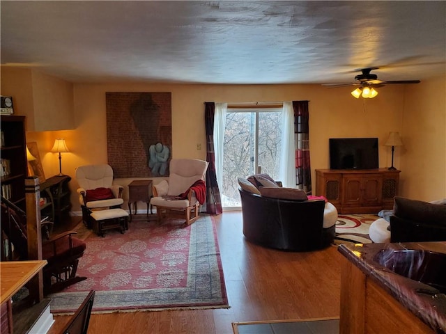 living room featuring hardwood / wood-style flooring and ceiling fan