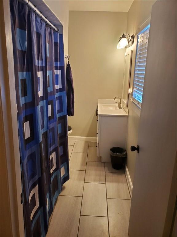 bathroom with vanity, tile patterned flooring, and toilet