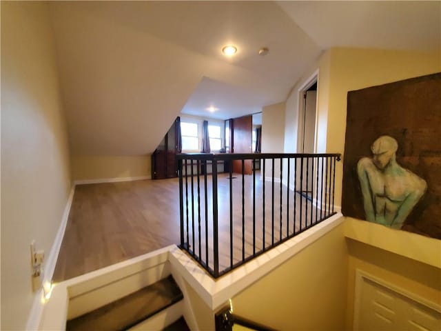 interior space with hardwood / wood-style flooring and vaulted ceiling