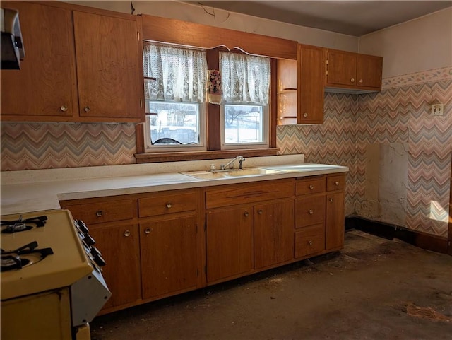 kitchen featuring decorative backsplash, extractor fan, sink, and gas range gas stove