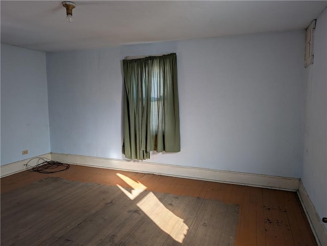 unfurnished room featuring hardwood / wood-style flooring