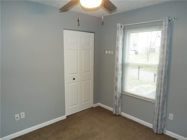 carpeted spare room with ceiling fan