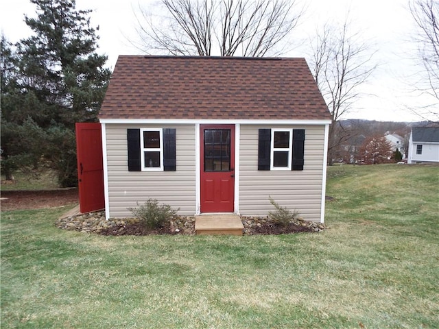 view of outbuilding with a yard