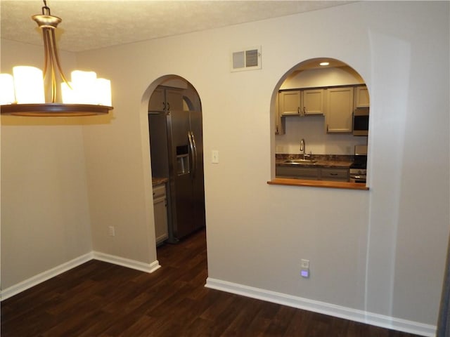 unfurnished dining area featuring dark hardwood / wood-style flooring and sink