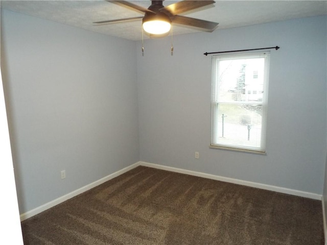 unfurnished room with dark carpet and ceiling fan