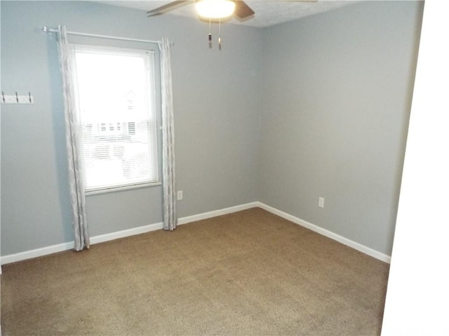 unfurnished room featuring ceiling fan and carpet flooring