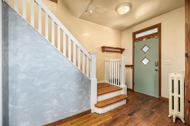 foyer featuring radiator and dark hardwood / wood-style flooring