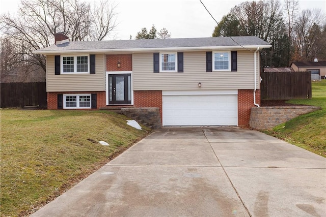 raised ranch with a garage and a front lawn