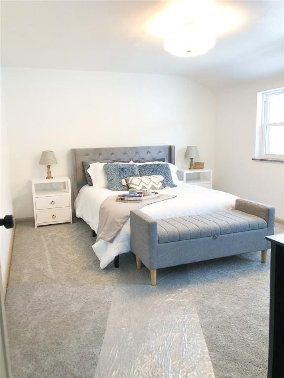 bedroom featuring vaulted ceiling and carpet