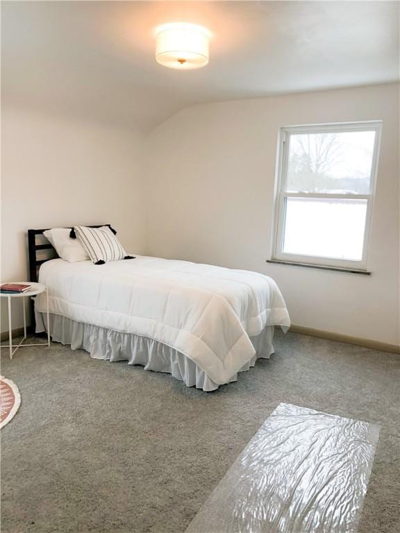 bedroom featuring light carpet and lofted ceiling