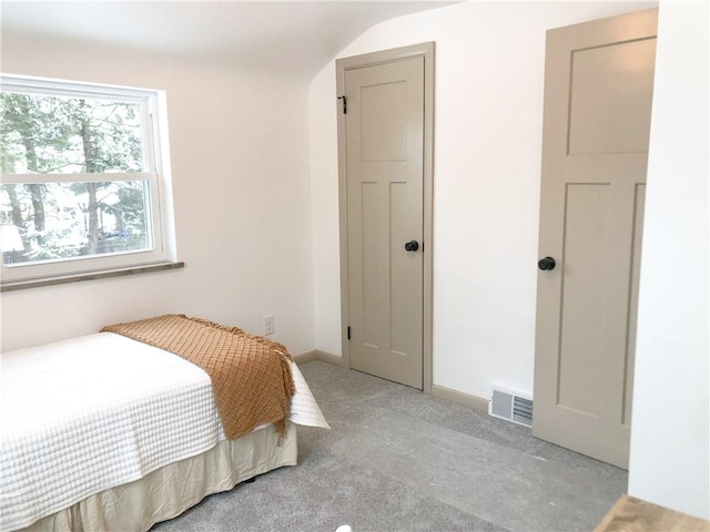 bedroom featuring light carpet