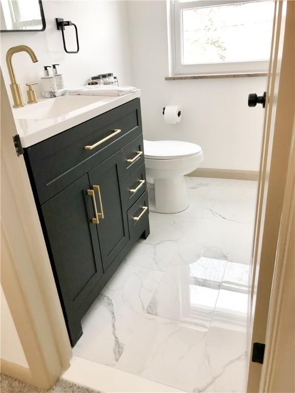 bathroom featuring vanity and toilet