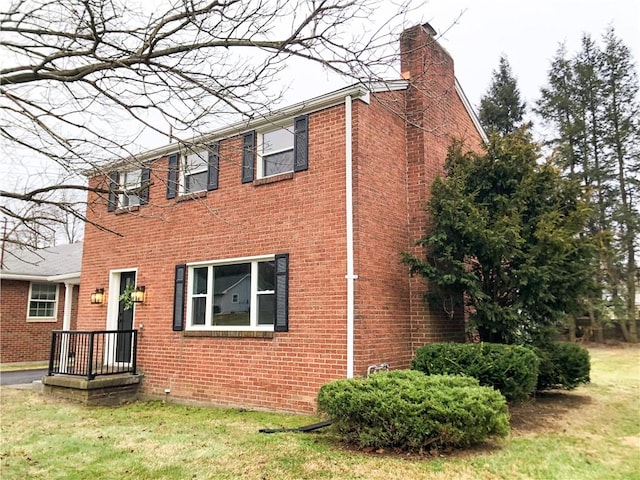 view of side of home with a lawn