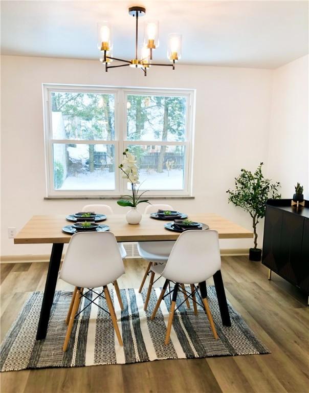 dining room featuring hardwood / wood-style flooring and a notable chandelier