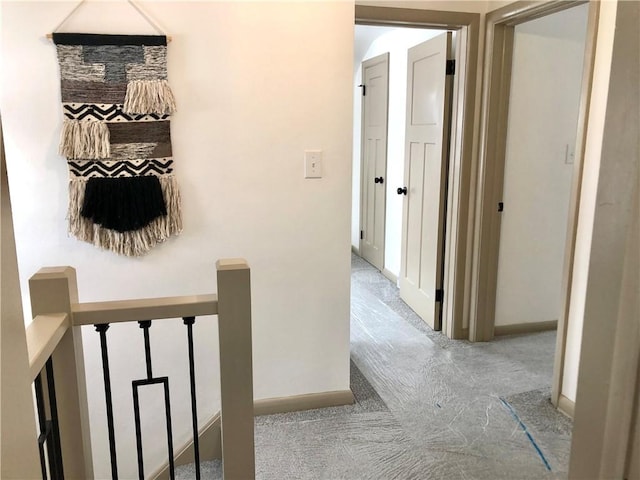 hallway featuring light colored carpet