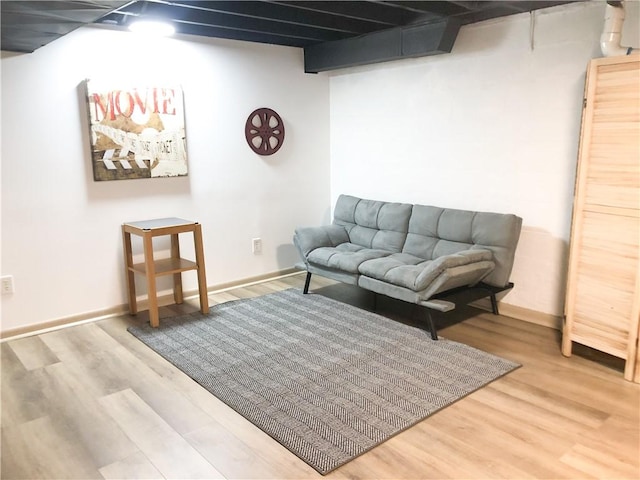 living room with beamed ceiling and hardwood / wood-style floors