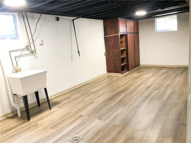 basement featuring light hardwood / wood-style floors