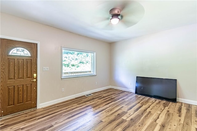 foyer with ceiling fan and light wood-type flooring