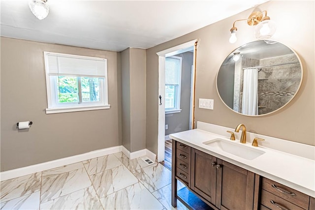 bathroom with walk in shower and vanity