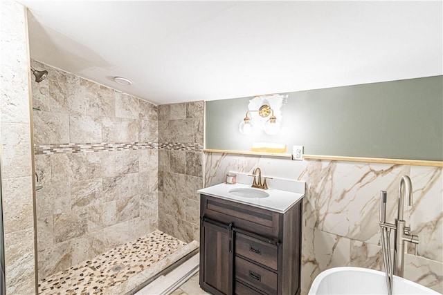 bathroom featuring tile walls, vanity, and a tile shower