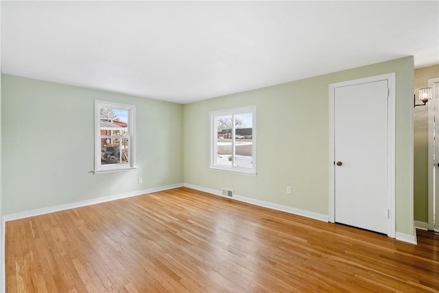 unfurnished room with light hardwood / wood-style floors