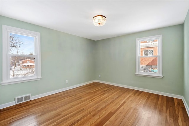 spare room featuring light hardwood / wood-style floors