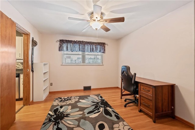 home office with ceiling fan and light wood-type flooring