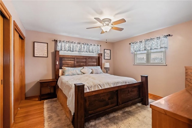 bedroom featuring light hardwood / wood-style floors, a closet, and ceiling fan