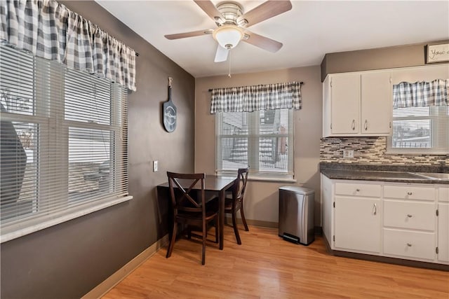 dining room with ceiling fan and light hardwood / wood-style flooring