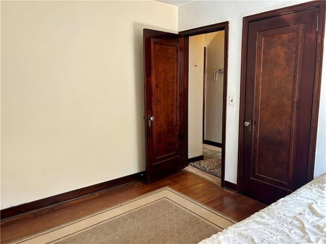 unfurnished bedroom featuring dark hardwood / wood-style flooring