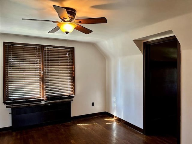 additional living space with dark wood-type flooring and ceiling fan