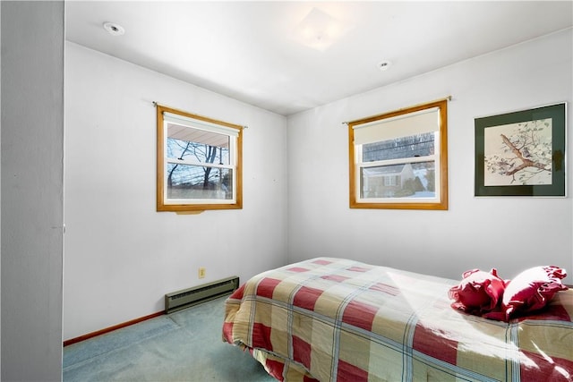 bedroom featuring carpet and a baseboard heating unit