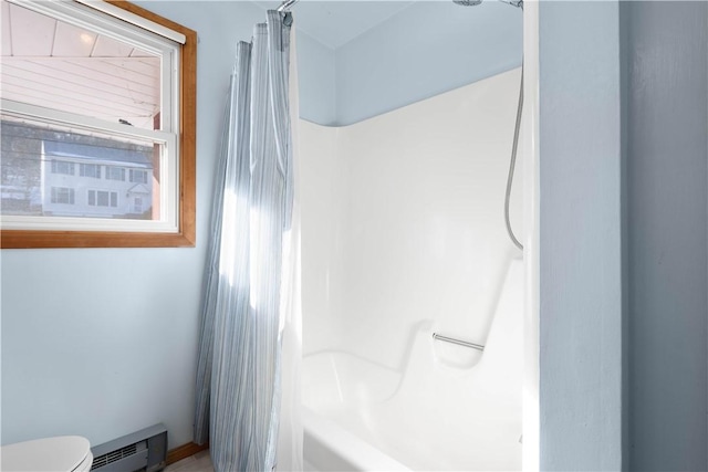 bathroom with toilet, shower / bath combo with shower curtain, and a baseboard heating unit