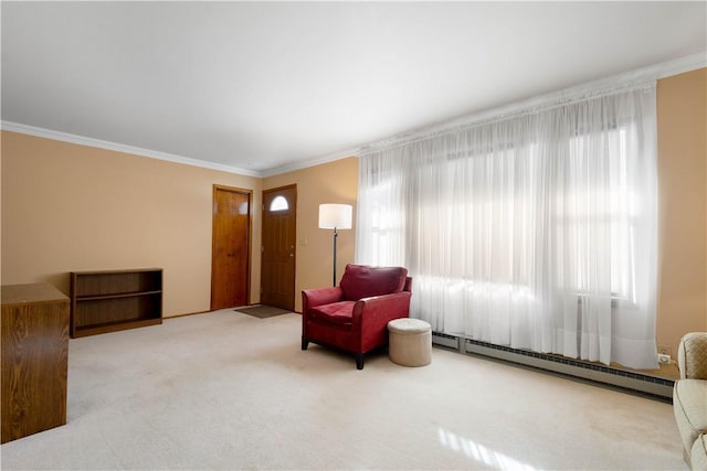 sitting room featuring crown molding, carpet flooring, and a baseboard heating unit