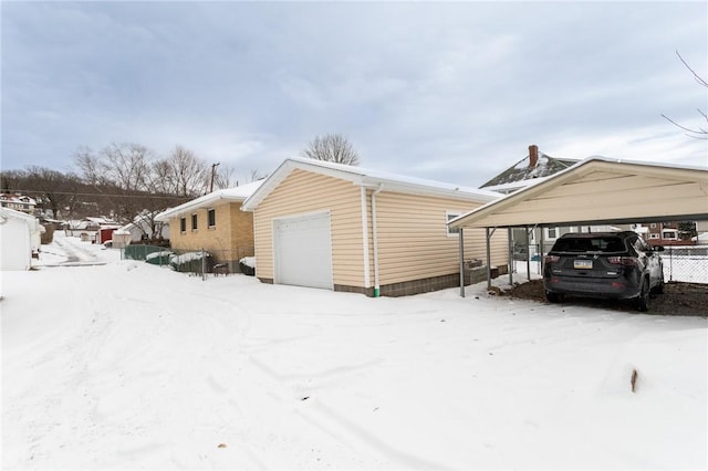 view of snowy exterior featuring a garage