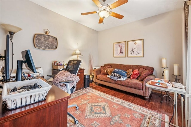 living room featuring dark wood-type flooring and ceiling fan