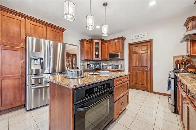 kitchen featuring a kitchen island, appliances with stainless steel finishes, decorative light fixtures, backsplash, and light tile patterned floors