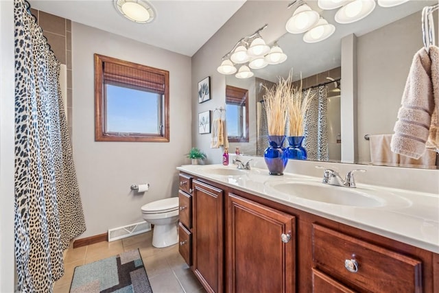 bathroom with tile patterned flooring, vanity, and toilet